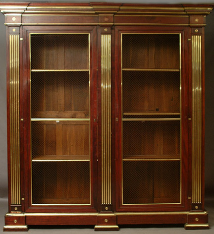 Louis XVI Style brass-mounted mahogany bookcase with stepped molded cornce above two large grilled doors separated by brass-fluted pilasters, on a plinth base.