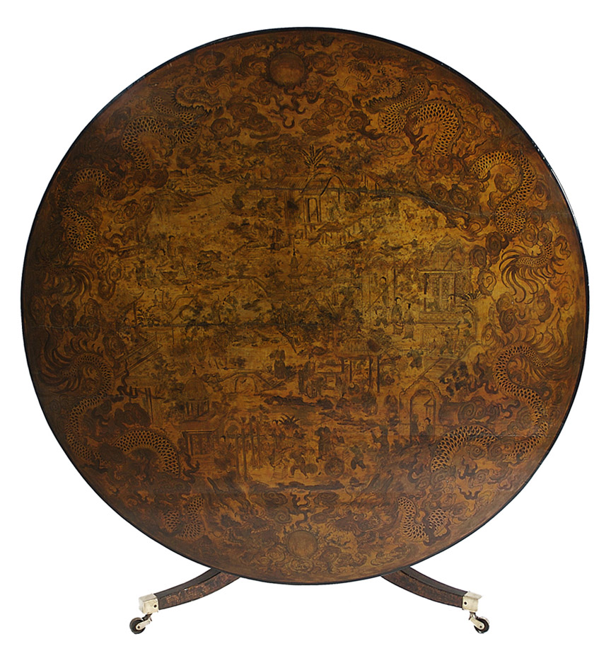 A wonderful Chinese Export lacquer center table with a palace courtyard central motif surrounded by mythological dragons, raised on a similarly decorated tripod base.
