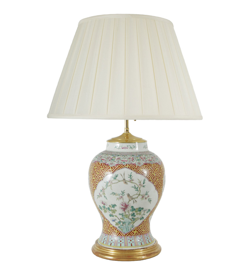 A pair of Chinese export famille rose enamelled baluster jars with reserves of birds and flowers on an iron red lattice ground; now mounted as lamps.
