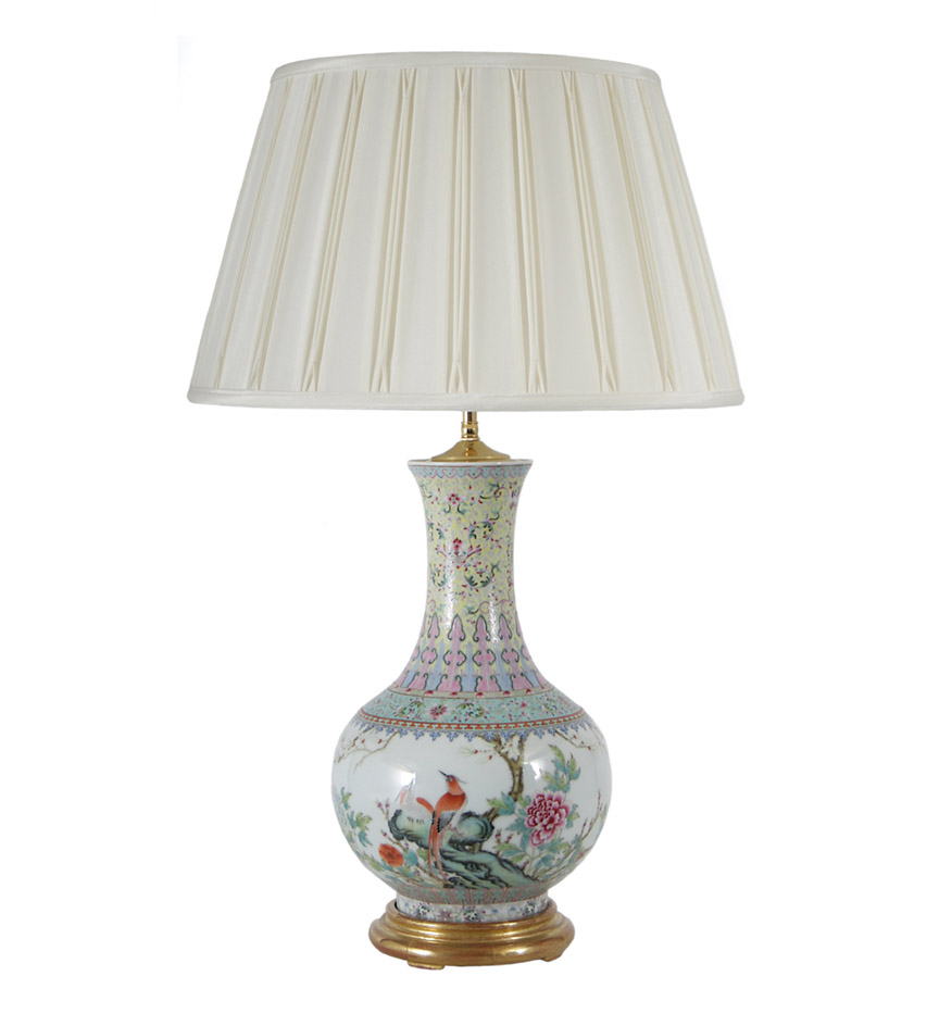 A Chinese export famille rose enamelled bottle vase decorated with birds and flowers beneath a yellow ground vinework neck; now mounted as a lamp.