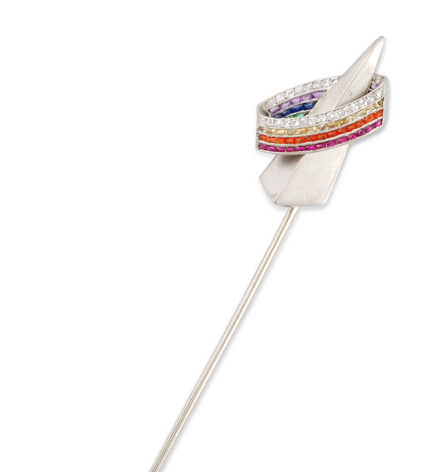 A rare Art Deco gem set and platinum stick pin, depicting the Trylon, a triangular building from the 1939 World's Fair representing the World of Tomorrow.  The ring includes sapphires, rubies, emeralds, citrines and orange feldspar.