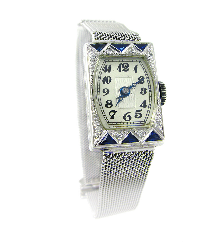 An Art Deco diamond and synthetic sapphire watch, on a white gold mesh band, in 18k.