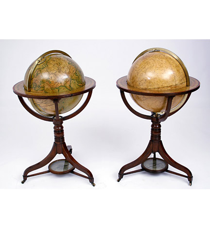 Pair of Regency terrestrial and celestial globes by Cary dated 1816, each in a mahogany stand with turned pedestal and tripod legs joined by stretchers centering a compass.