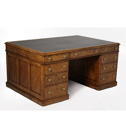 A Victorian burled walnut partner's pedestal desk, the inset leather top above three frieze drawers, the pedestals with paneled ends and fitted on each side with graduated drawers, on casters.  Provenance: Stair and Company, New York.