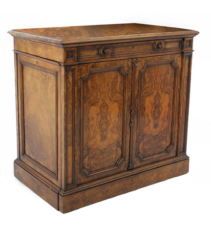 Early Victorian walnut folio cabinet, the molded top projecting over a drawer with button pulls, a panelled drop-front, each side with cupboarsd doors opening to sectioned interior.
