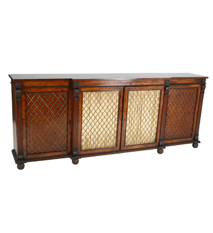 Regency mahogany breakfront chiffonier with four fabric-backed grilled doors revealing drawers and shelves and flanked by volute headed pilasters, and resting on lobed feet.