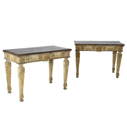 A pair of Continental neo-classical console tables, each with faux marble top above a stop-fluted frieze centering a lion's mask and raised on tapering square legs with masks over oak leaf clusters, painted white and parcel gilt.