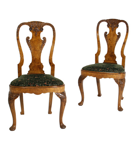 Set of four George II style carved walnut side chairs with vase-form splats, drop-in seats and leaf-carved cabriole legs.