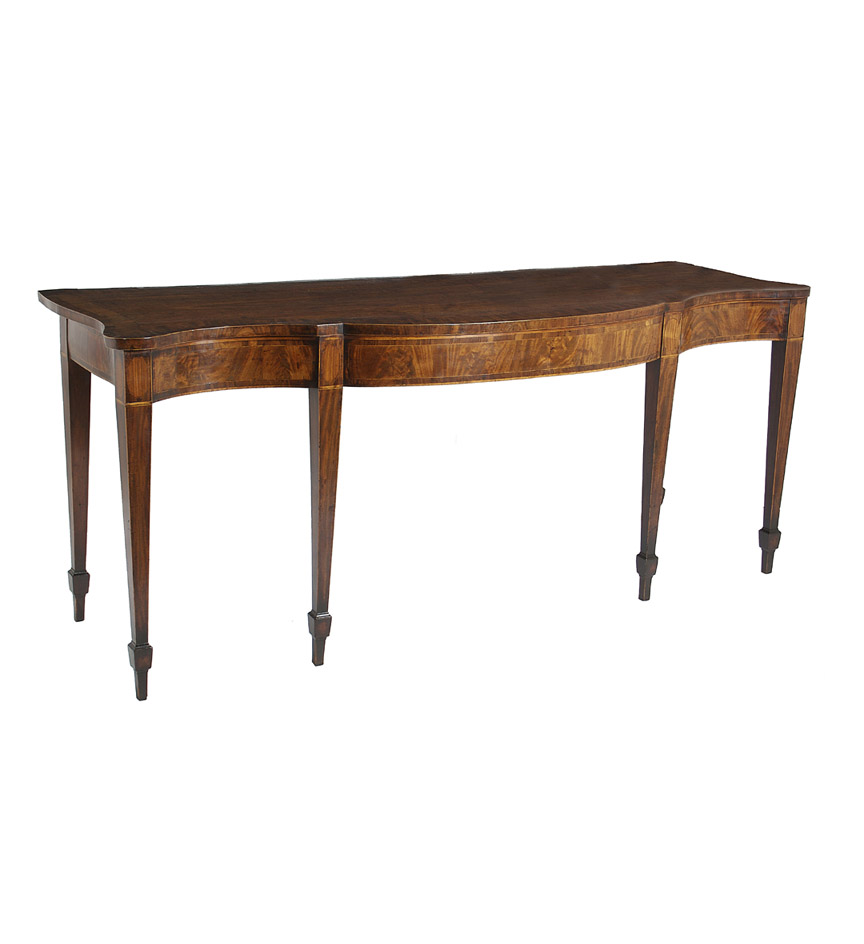 A George III mahogany serving table, the serpentine top with rosewood and mahogany crossbanded borders within string inlay above a conforming string-inlaid frieze raised on square tapering cuffed legs.