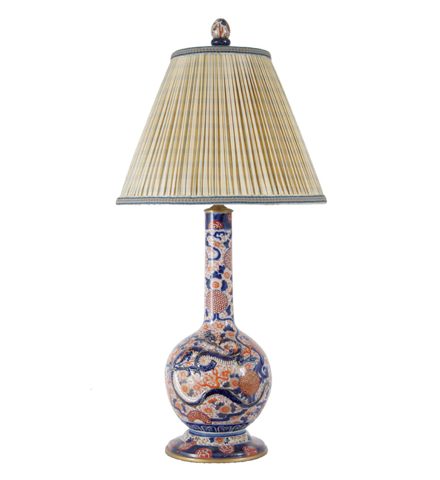 A pair of Chinese export porcelain large bottle form vases in the Imari palette, now mounted as lamps with custom silk shades.