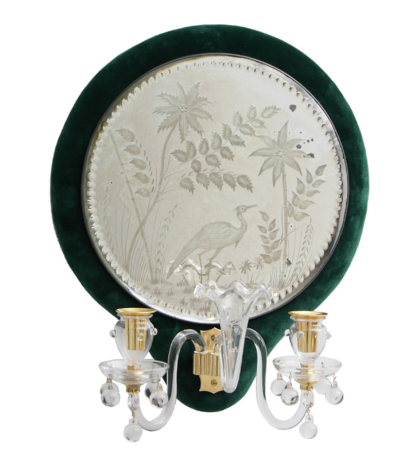 A pair of green velvet backed circular mirrored glass sconces with engraved decoration of birds, probably  Osler.