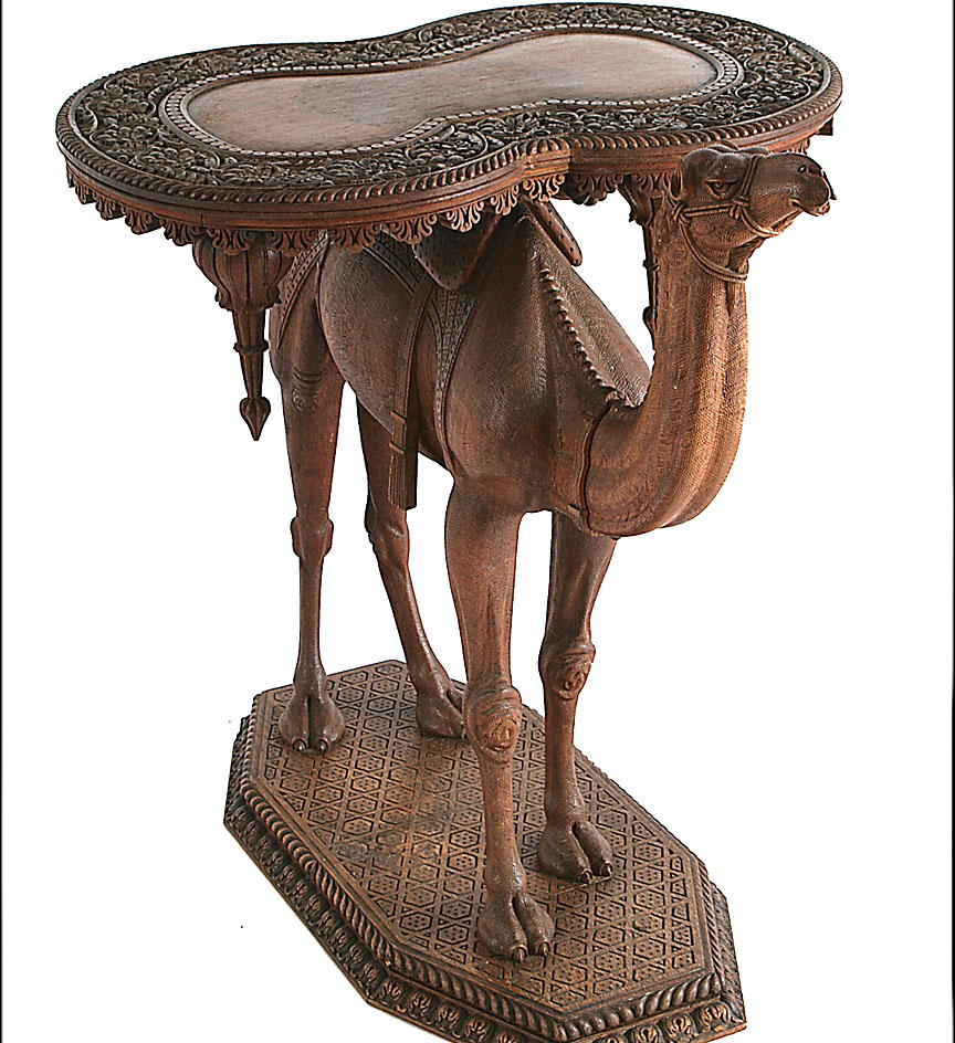 A Syrian carved sandalwood table modeled as standing camel with an hour-glass shaped table top. 