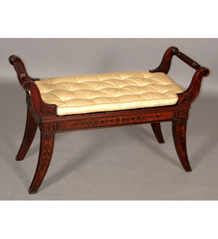 Fine pair of Regency style ebony-inlaid  mahogany Klismos benches in the manner of Thomas Hope. The highly figured veneer to the S-curved arms, seatrail and splayed legs inlaid with stylized flowerhead and anthemion decoration.  A very similar design using lion paw feet can be found in Hope's 