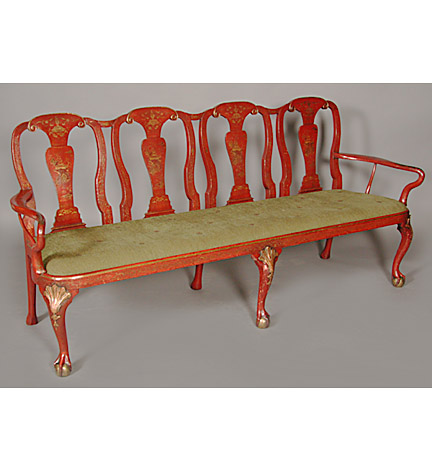Exceptional Chinese red lacquer chairback settee, each of the four chairbacks with scrolled arched toprails, curved supports and solid splats, the shepherd's crook arms and drop-in padded seat on a molded seatrail and shell and bellflower carved cabriole legs on claw and ball feet.    Provenance:  The John Keil Collection, London