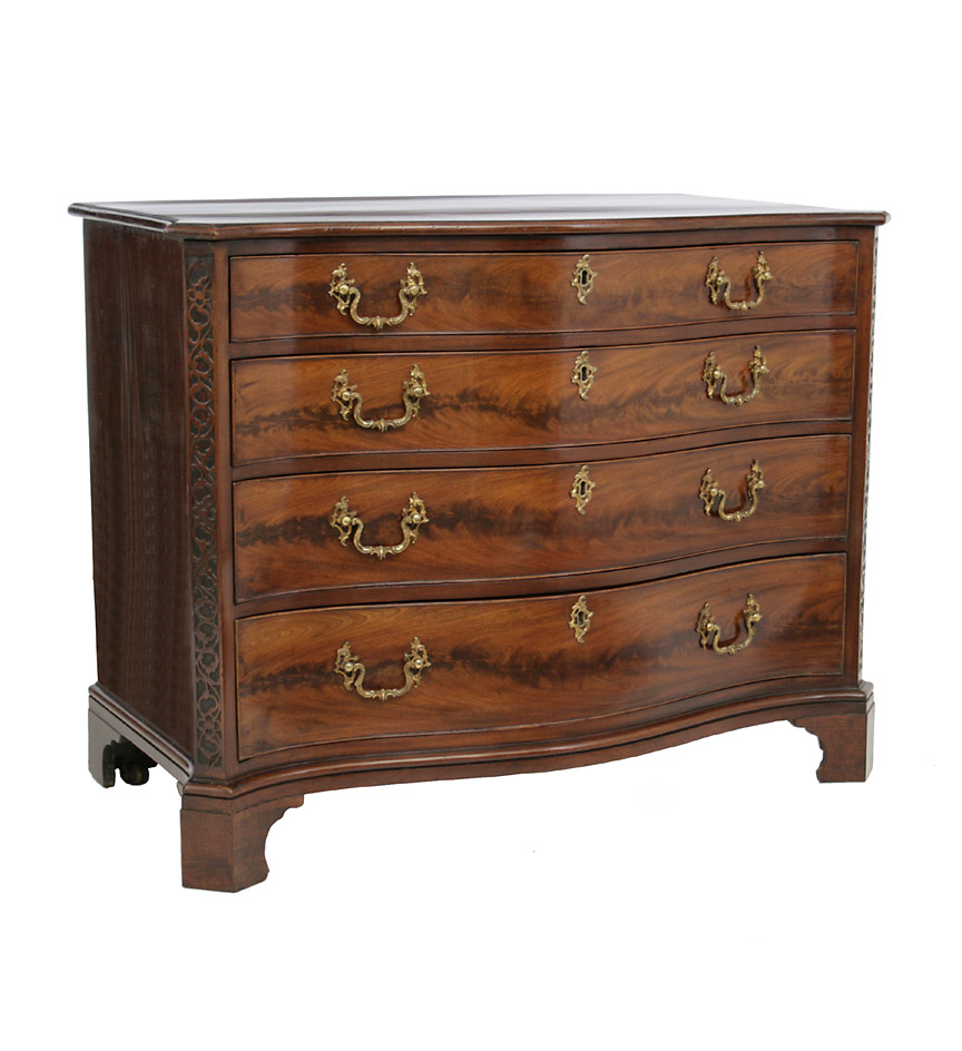 A finely proportioned George III serpentine mahogany chest of drawers, the molded-edge top with outset corners over blind fret uprights, each of the four graduated drawers with highly figured veneers.