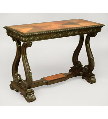 Fine 19th century Anglo-Indian ebony center table with specimen wood top, the gadrooned edge above a shell and scroll carved frieze and raised on S-curved trestle supports joined by a stretcher.