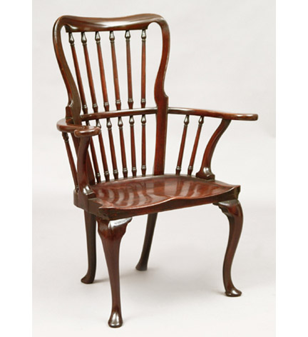 Good George II mahogany Windsor form armchair with an arched back fitted with baluster turned spindles, outscrolled arm terminals, shaped seat, and cabriole legs terminating in pad feet.