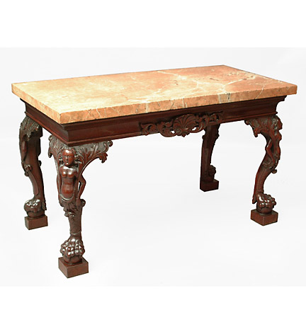 Irish George II style marble-topped carved mahogany console table, the cavetto molded frieze centering a shell and raised on female term-carved legs ending in paw and ball feet.