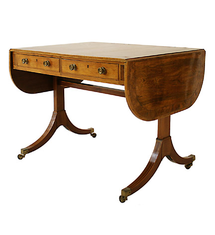 Regency rosewood drop-leaf sofa table with yewwood banding and boxwood stringing, the frieze fitted with two drawers and  raised on mahogany trestle supports ending in brass casters.