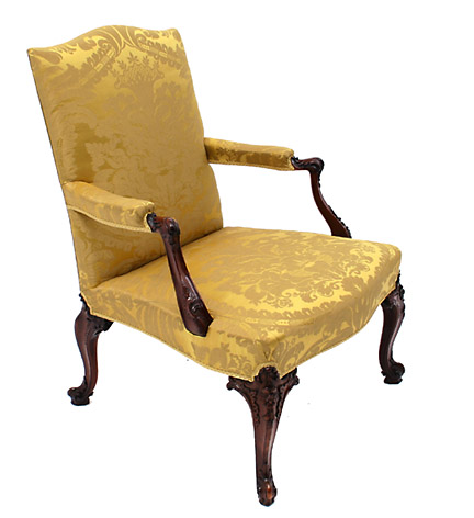 A superb George II period mahogany Gainsborough armchair in the Chippendale Rococo taste, raised on cabriole legs with floral carved  knees ending in cabochon headed French feet, with upholstered armrests supported by downswept arms ending with carved cabochon clasps.