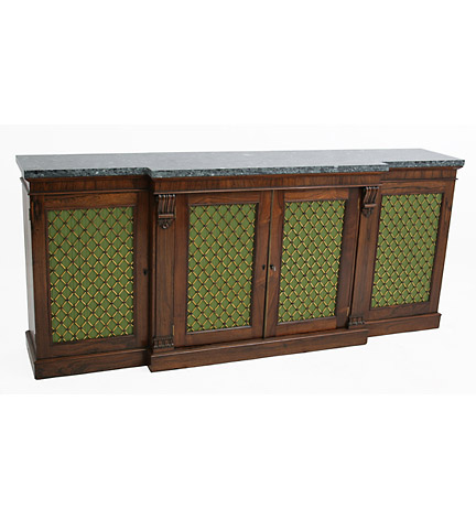 A Regency marble-topped rosewood breakfront chiffonier with volute carved pilasters and grilled fabric-backed doors.