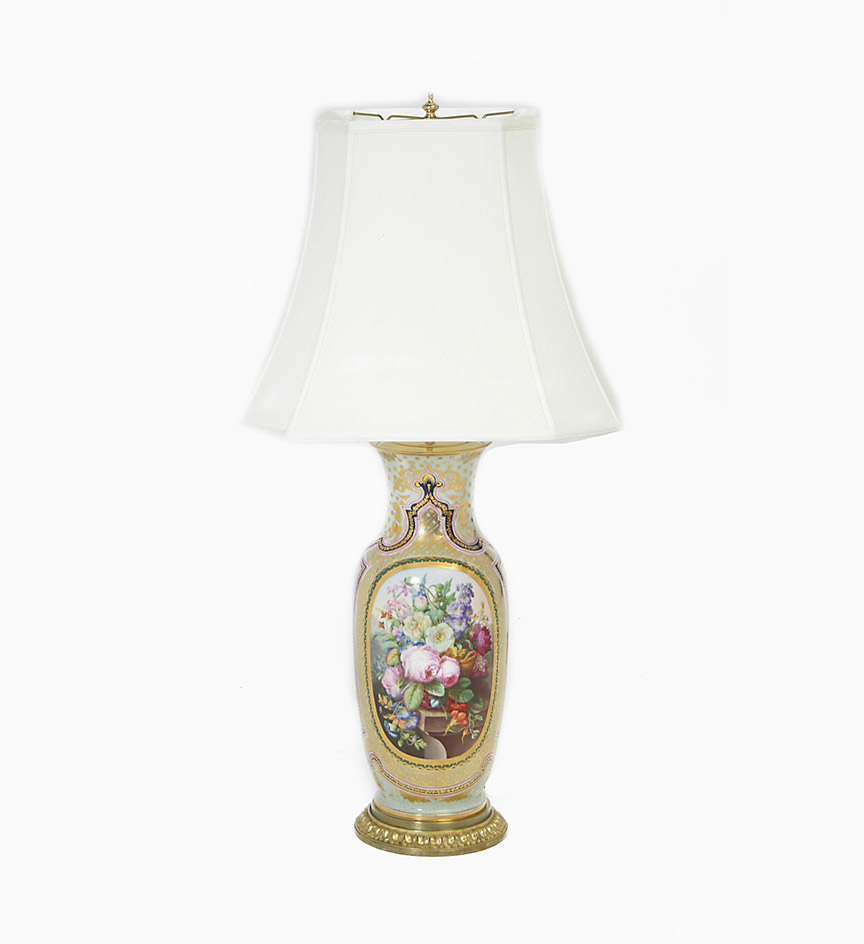A pair of good French Paris porcelain baluster vases mounted as lamps, with reserves of floral bouquets to a gilt decorated pale green ground.