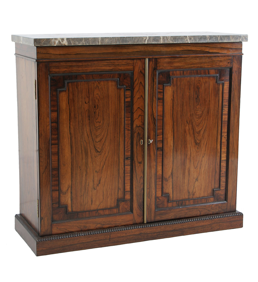 A William IV marble-topped rosewood side cabinet or chiffonier with a pair of crossbanded paneled doors resting on a plinth base with beaded molding.