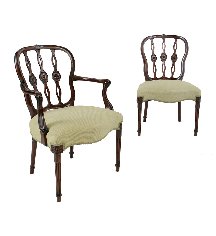 A good set of 12 Hepplewhite style mahogany dining chairs, each cartouche-form back with three pierced and flowerhead decorated splats, overupholstered serpentine seats and raised on tapering stop-fluted legs headed by anthemia.