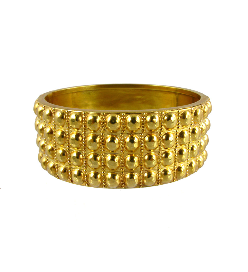 An antique silver gilt bangle with four rows of half beaded decoration.