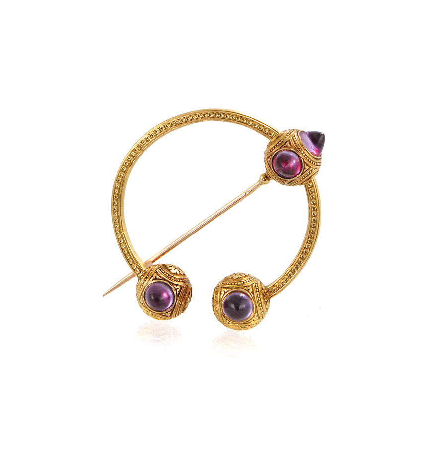 An antique engraved gold penanular brooch set with buff top amethysts, in 18k. France
